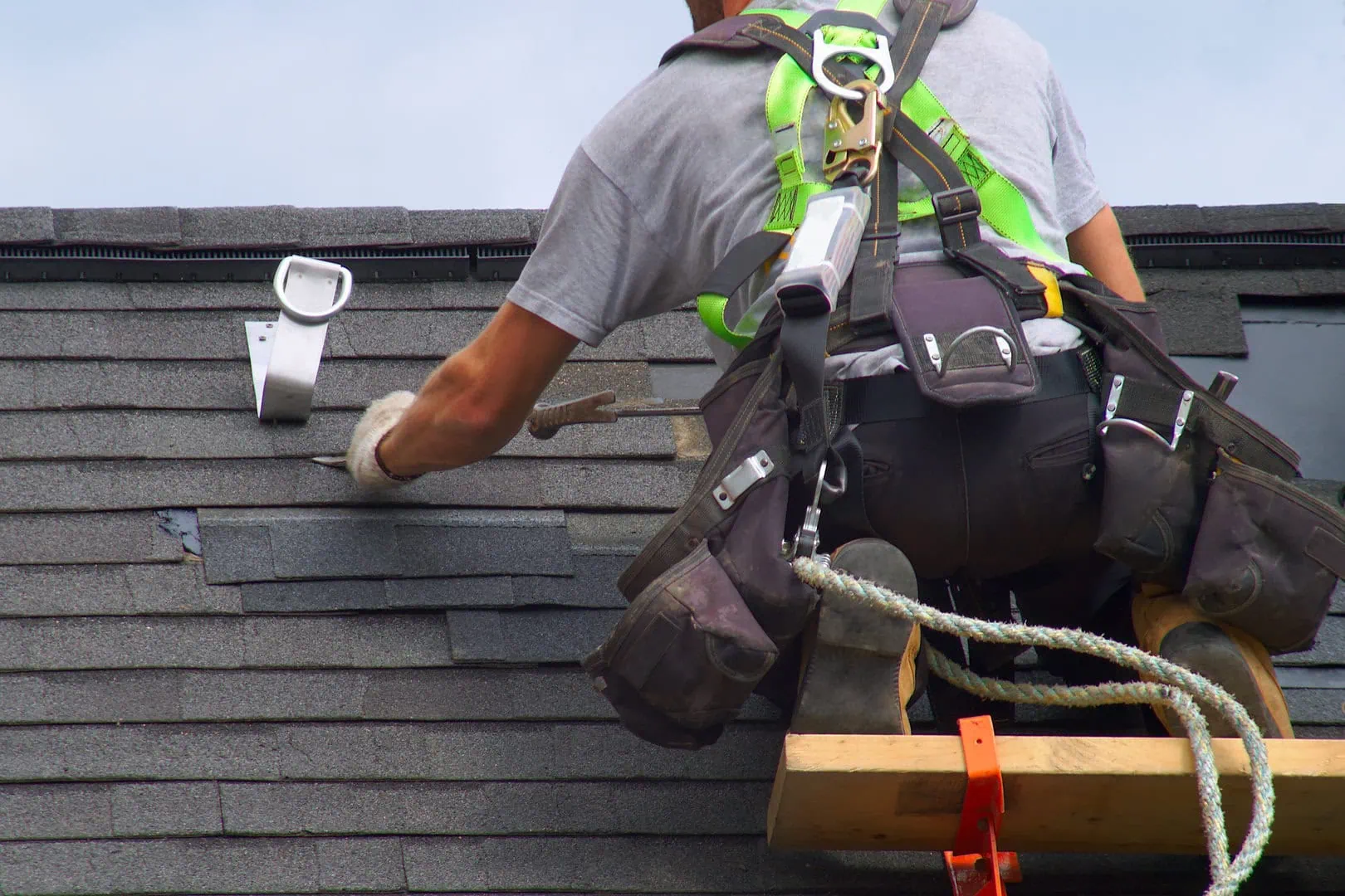 roofer installing roof shingles